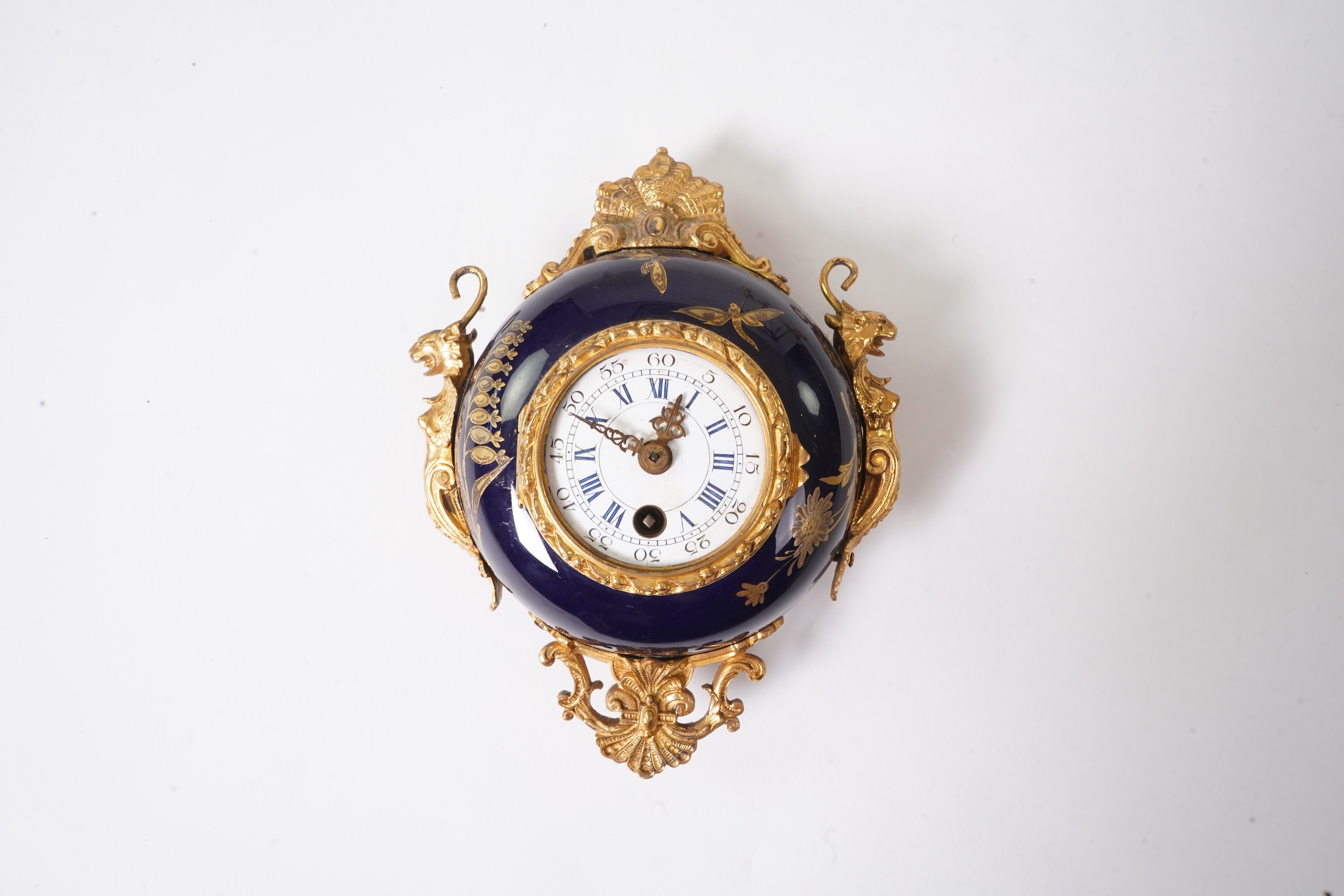 An unusual enamel and gilt brass timepiece, pendant from gilt brass frame, stand 26cm high. Condition - dismantled